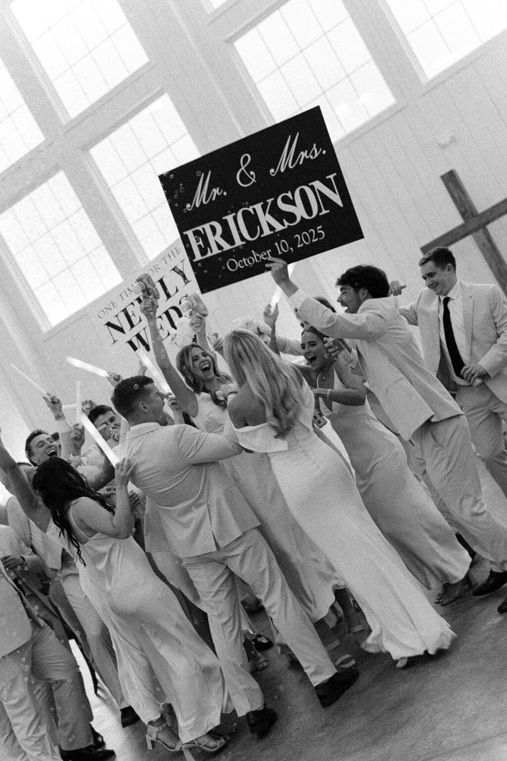 timeless image of wedding part carrying signs on dance floor