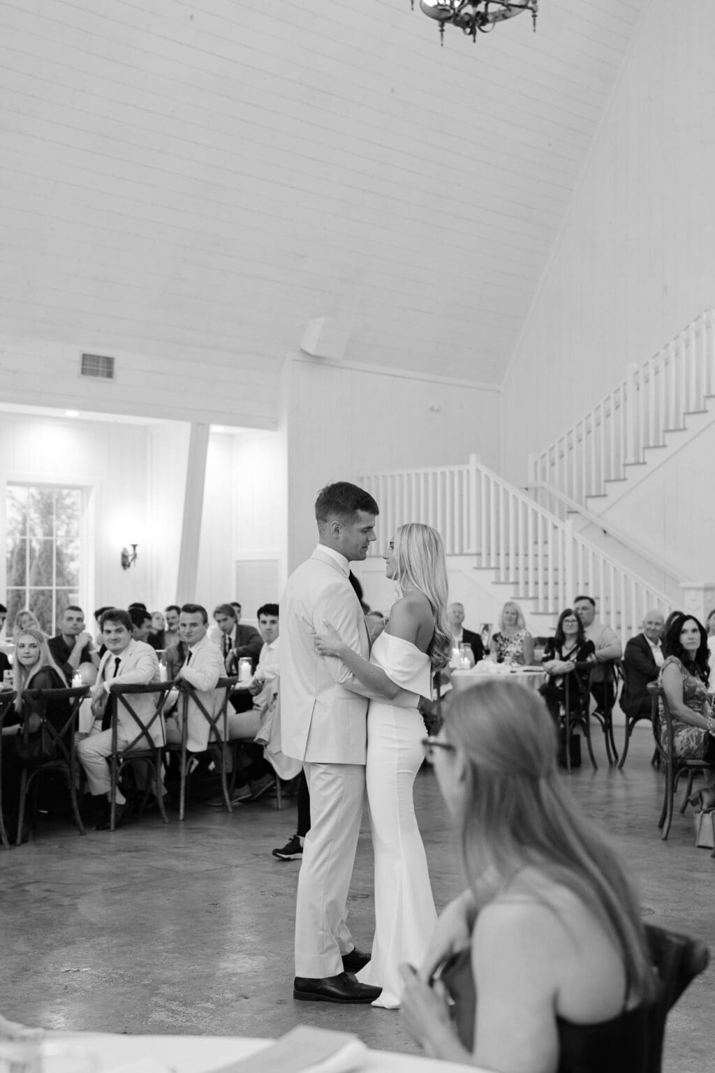 black and white image of bride and groom on dance floor