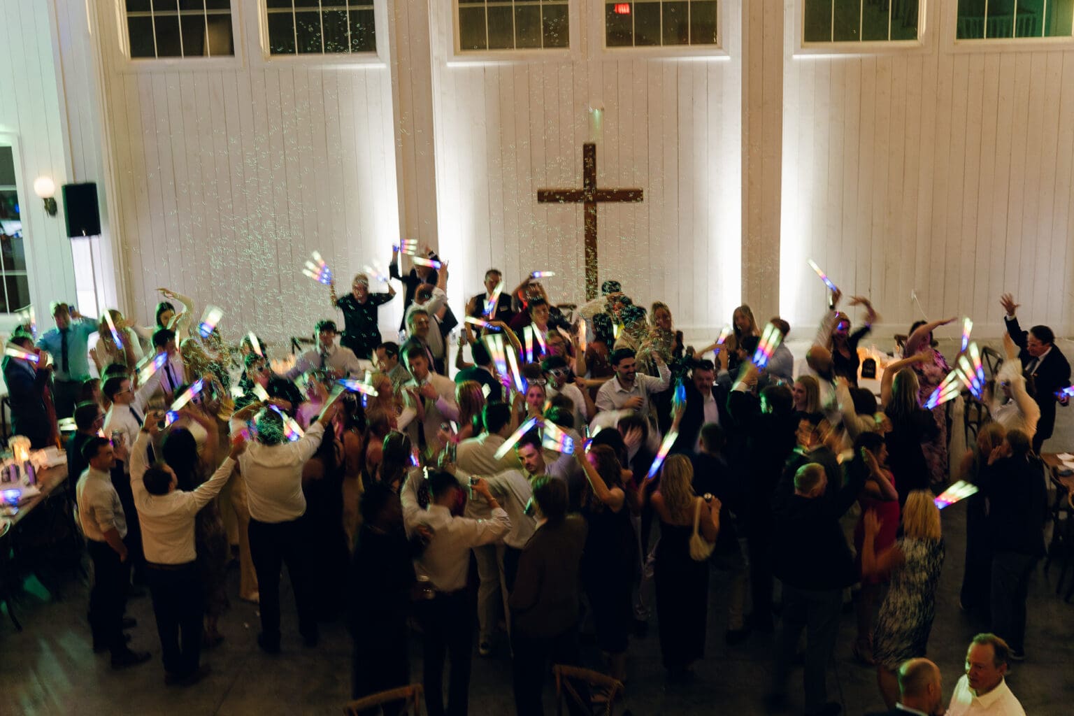 people on the dance floor with colorful light wands and bubbles at Haven on the Farm